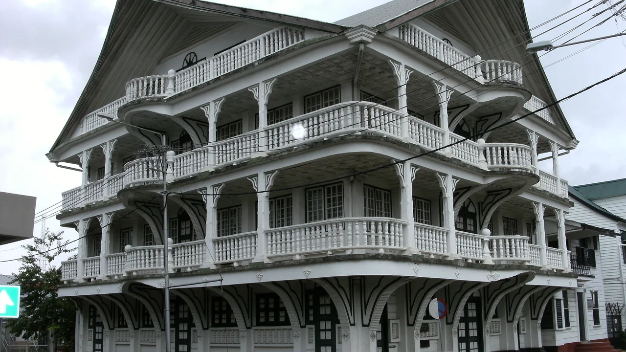 Colonial wooden mansion on Lim A Po Straat with an elaborate columned portico and symmetrical facade.