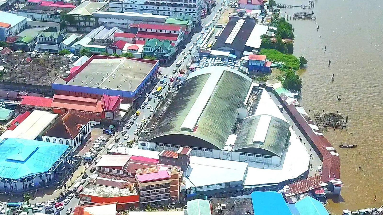Exterior view of the covered Central Market halls along the Suriname River waterfront.