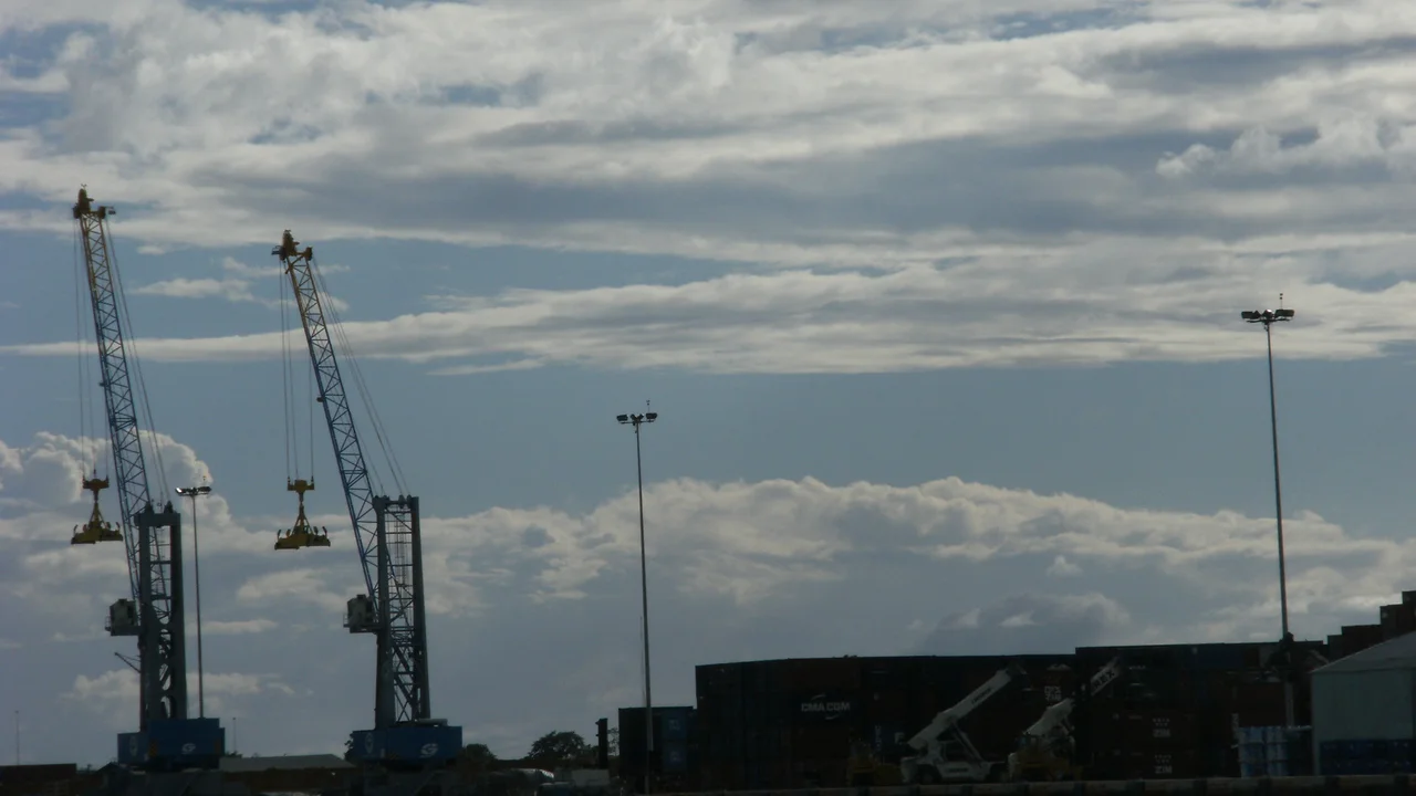 Paved container staging yard and concrete marginal wharf infrastructure at the Port of Paramaribo.